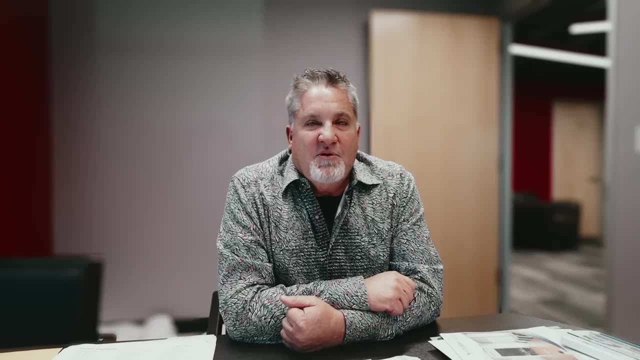 Company founder interviewed at a desk