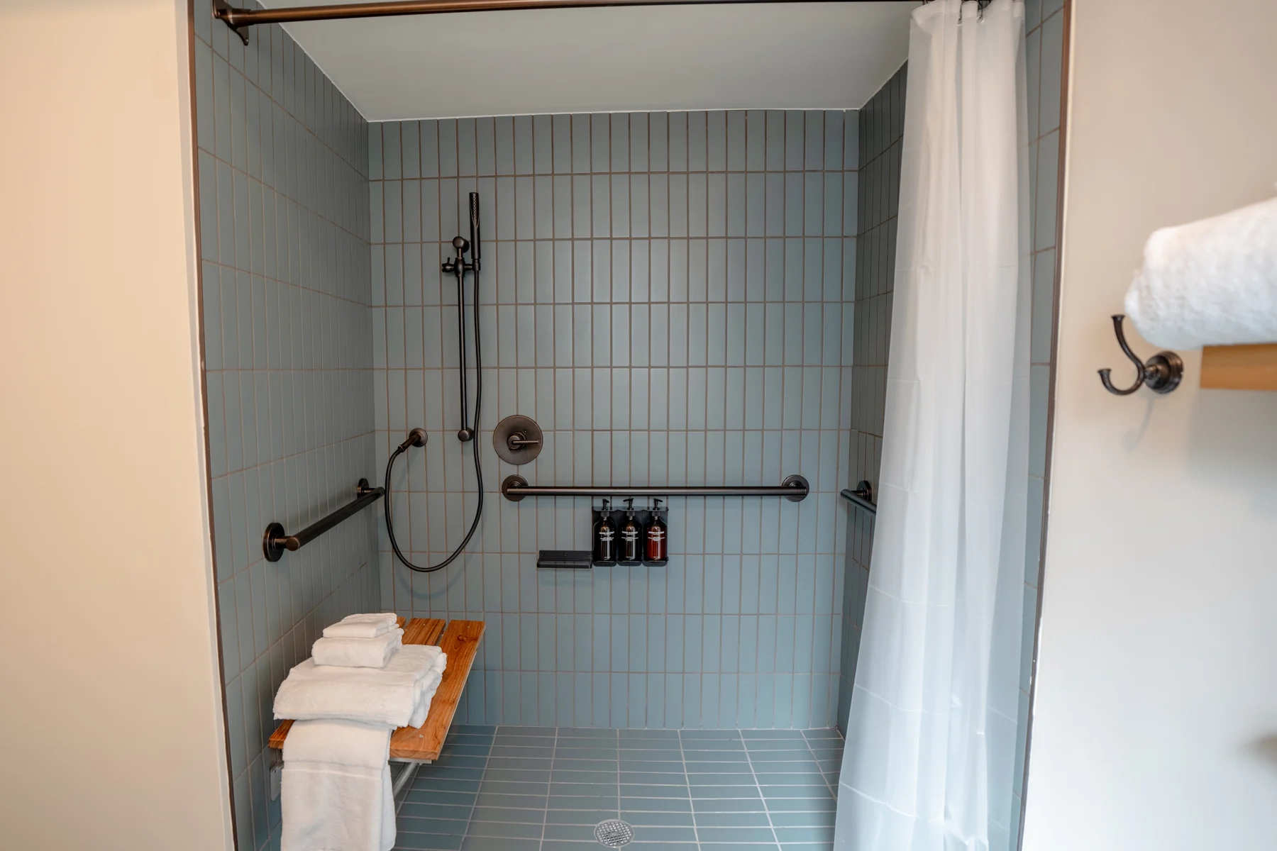 Tiled walk-in shower with grab bars