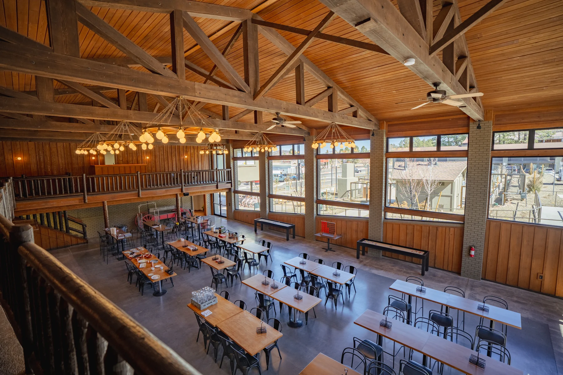 Timber-framed dining hall seen from a balcony