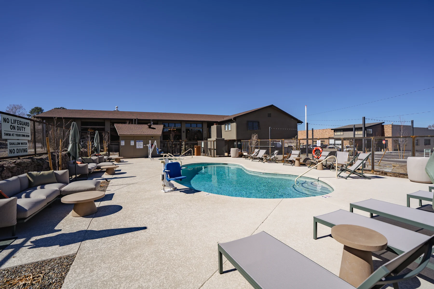 Hotel pool courtyard with lounge chairs
