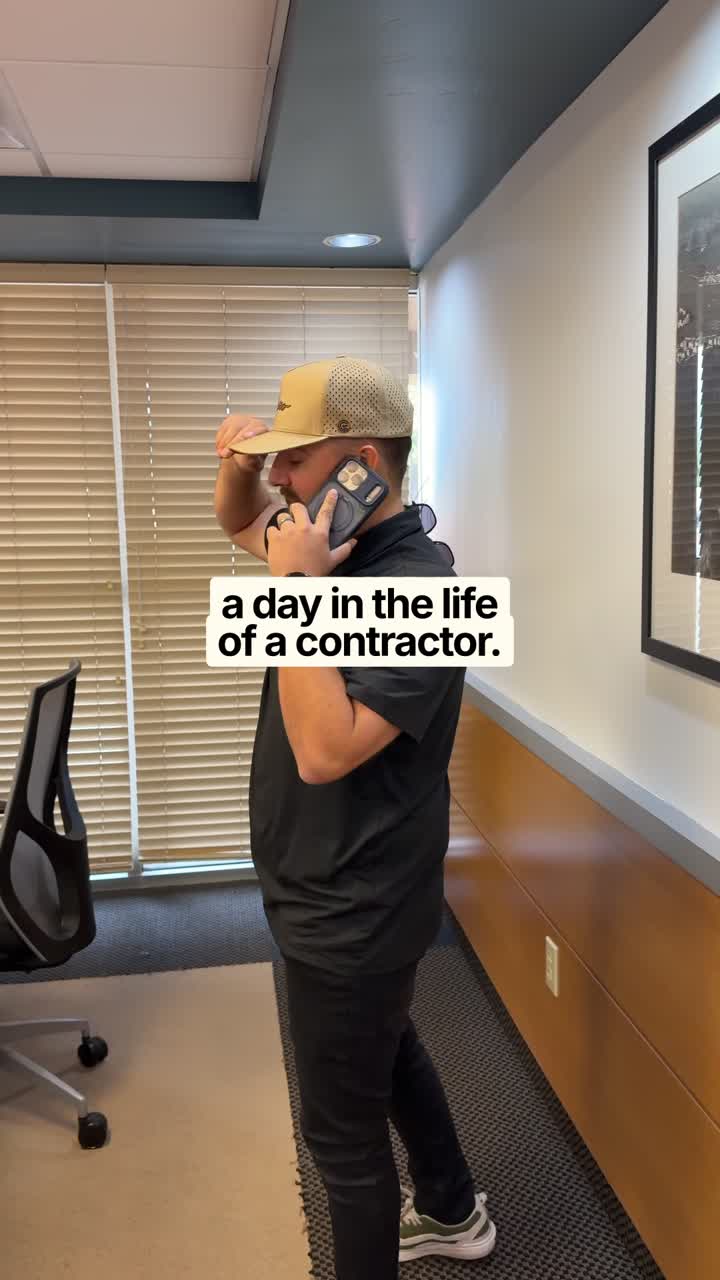 Contractor on a phone call in a remodeled hallway