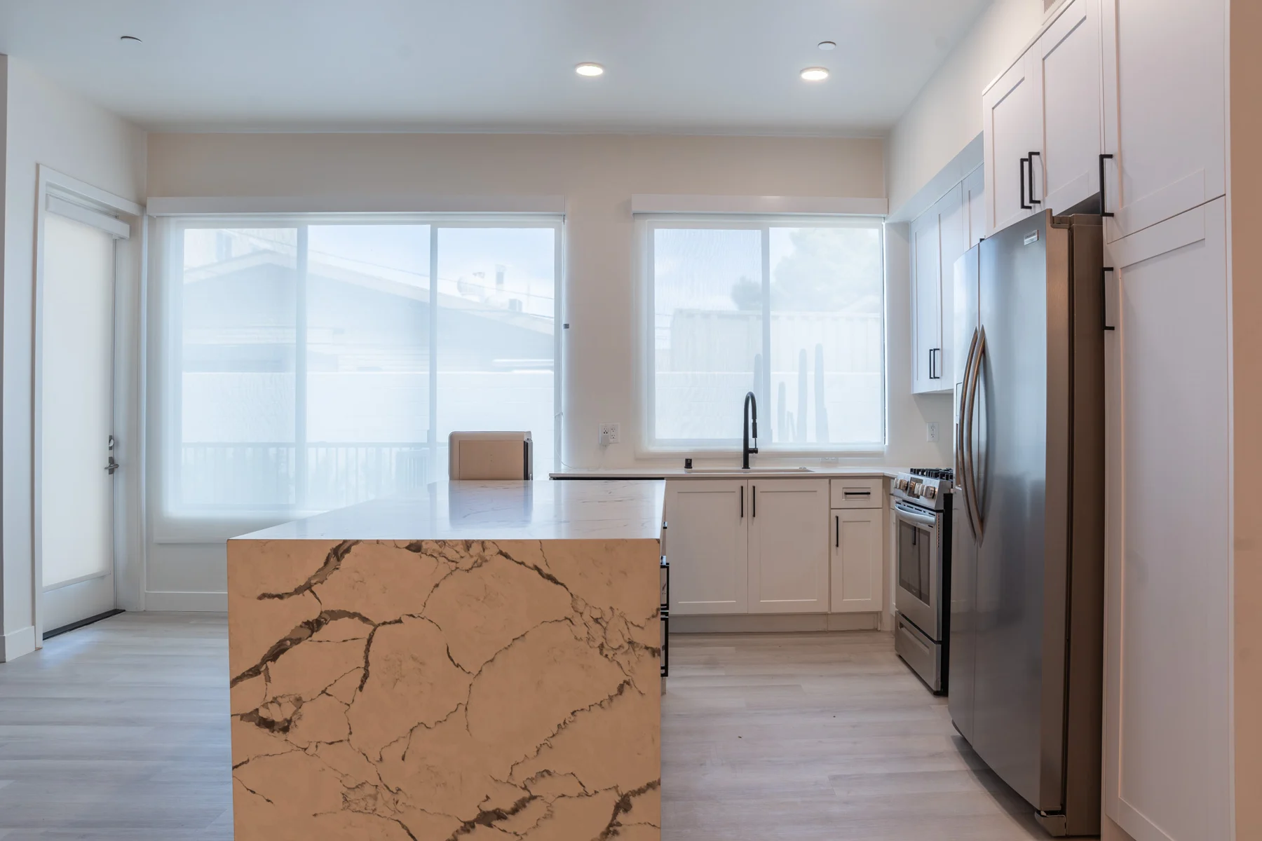 Finished kitchen with a stone waterfall island