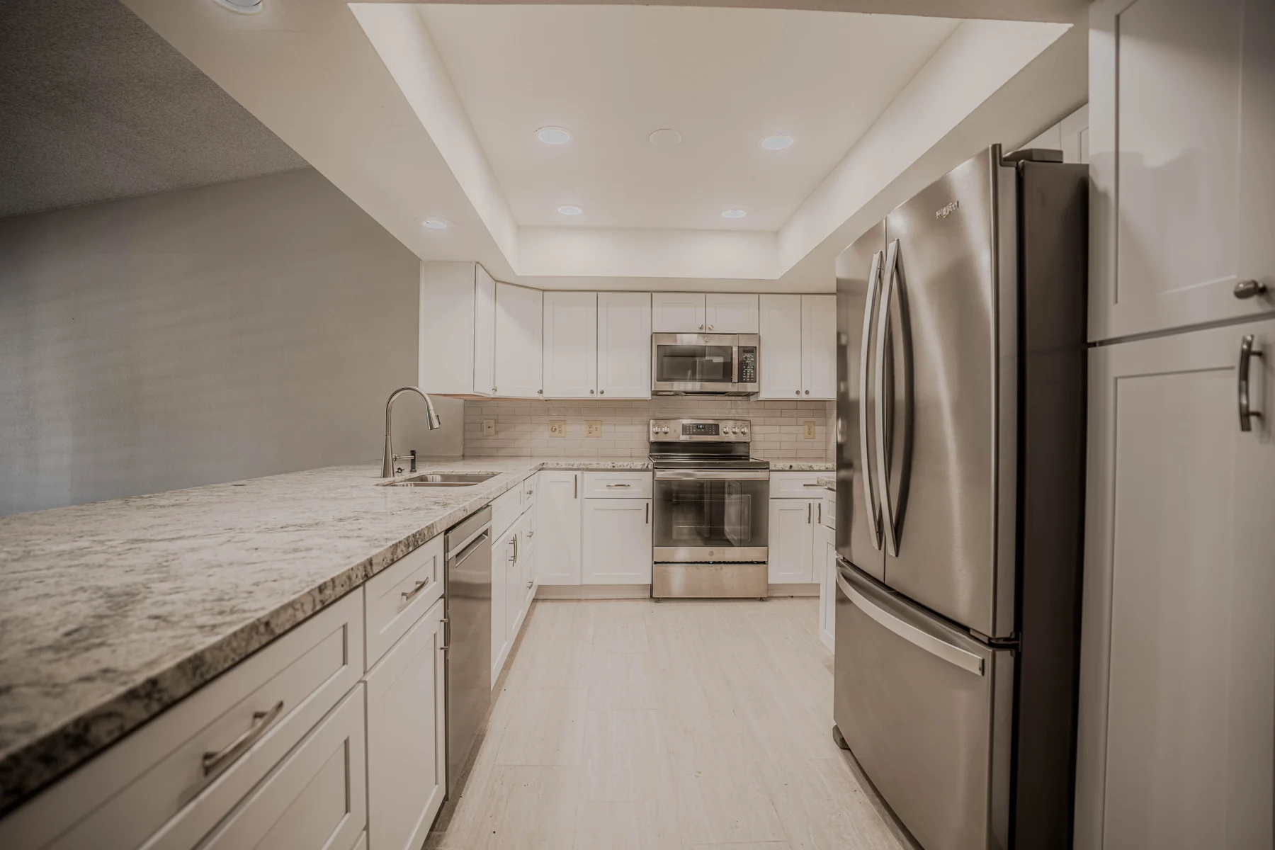 Remodeled kitchen with white shaker cabinets
